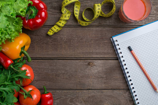 istock Sport and diet. Vegetables and centimeter. Peppers, tomatoes, salad on rustic background 681890940