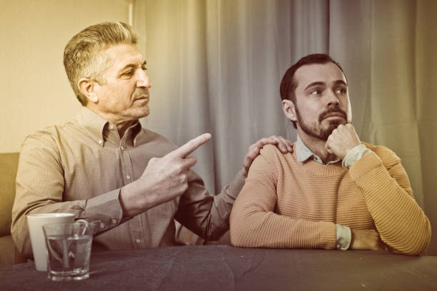 istock Mature father and son serious talk 681895460