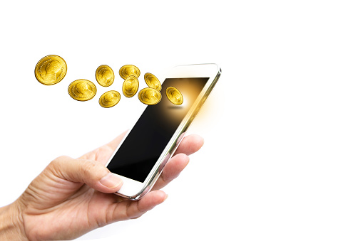 Woman hand holding smart phone and earning gold coins