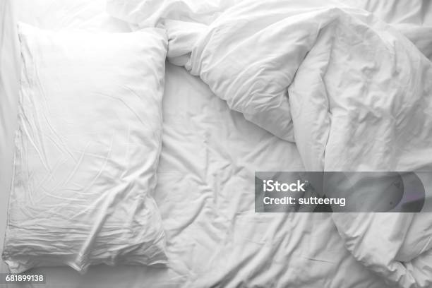 Messy Bed White Pillow With Blanket On Bed Unmade Concept Of Relaxing After Morning Stock Photo - Download Image Now