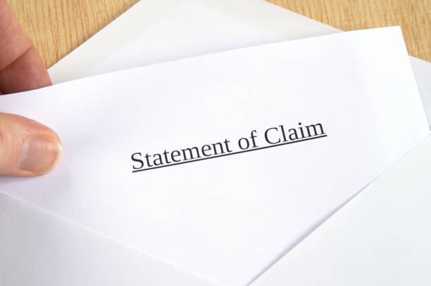 istock Statement of Claim printed on white paper and envelope, hand holding it, wooden background 681899166