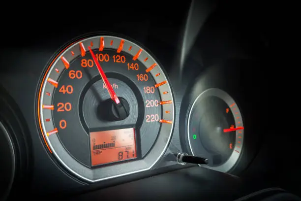 Photo of Closeup car dashboard. Speeding on 80 km per hour. Safety speeding. Detail of transportation.