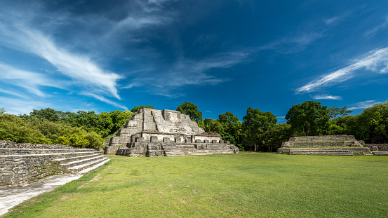 Panorama of Altun Ha Complex with Temple of the Sun God - Sun God's Tomb in famous ancient Mayan City Altun Ha (translated: Rockstone Water), under blue summer sky. Altun Ha was occupied for many centuries, from about B.C. 900 to A.D. 1000. Altun Ha, 50km North of Belize City, Belize, Central America.