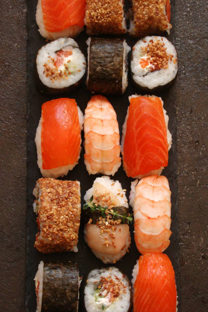 istock sushi and sushi rolls, sushi nigiri on stone plate 681900488