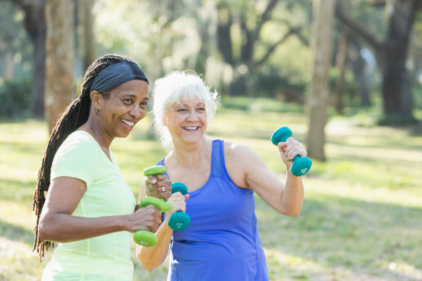 istock Two senior women exercising in park with hand weights 681902998