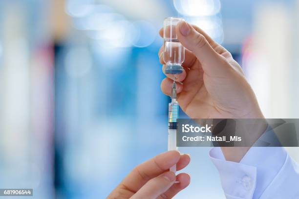 The Doctor Fills A Syringe With Vaccine Stock Photo - Download Image Now - Injecting, Syringe, Vaccination
