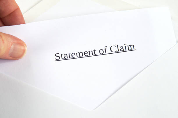 istock Statement of Claim printed on white paper and envelope, hand holding it, white background 681907052