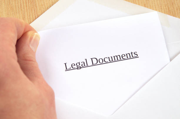 istock Legal Documents printed on white paper and envelope, hand holding it, wooden background 681907152