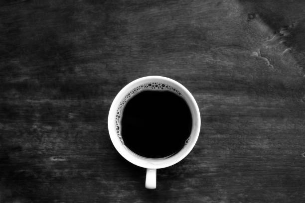istock Black coffee in black wooden  table 681910996
