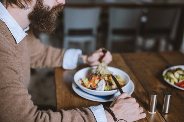 istock Close up of man with beard eating a salad 681917722