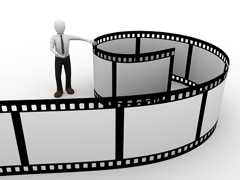 A man presenting a rolled film. Cinema Concept