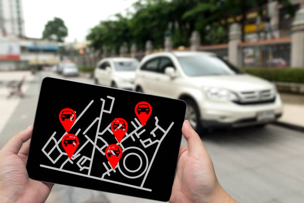 Car sharing service or rental concept. Sharing economy and collaborative consumption. Man hand holding tablet with icons application screen and blur car park background. Car sharing service or rental concept. Sharing economy and collaborative consumption. Man hand holding tablet with icons application screen and blur car park background. carsharing photos stock pictures, royalty-free photos & images