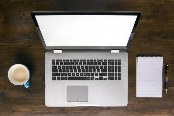 istock laptop on desk with coffee and notepad top view 681932404