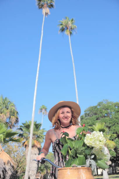istock Woman riding bicycle in a tropical park. 681932672