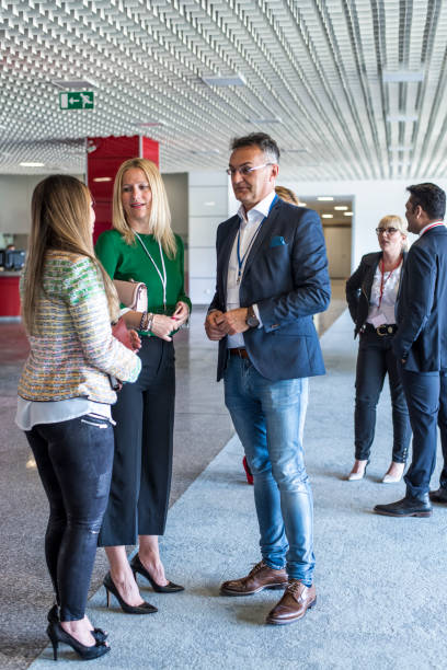 istock Business people talking in the office building lobby 681939000