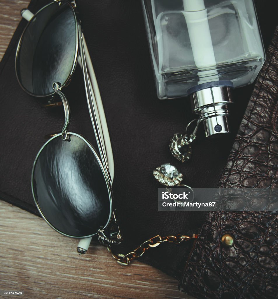 Top view of female fashion accessories. Perfume with sunglasses Adult Stock Photo