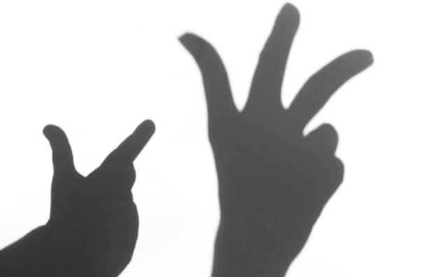 istock the shadow of the hand white background close-up 681940262