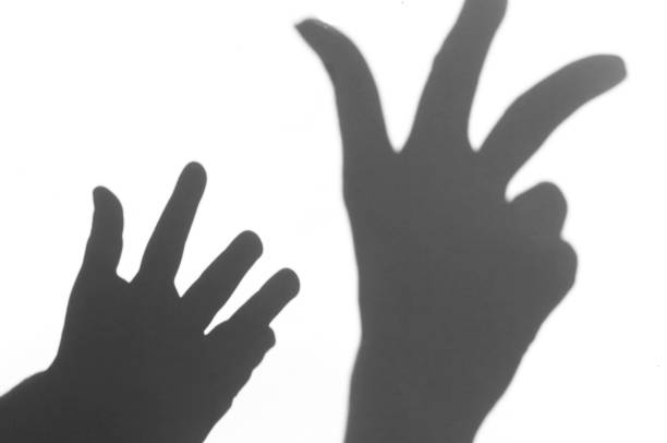 istock the shadow of the hand white background close-up 681942430