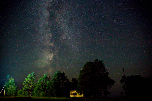 istock Night starry sky scene with illuminated cottage 681946106