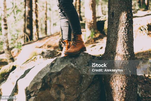 Female Legs Shod In Hiking Boots On The Forest Background Travel Concept Stock Photo - Download Image Now