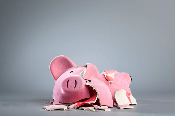 istock Broken Piggy Bank Against Gray Background 681958973