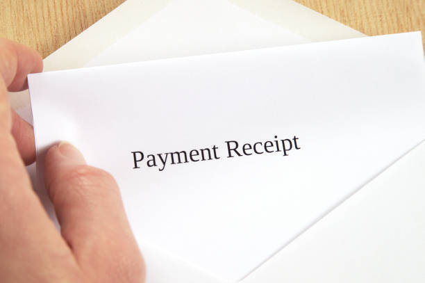 istock Payment Receipt printed on white paper and envelope, hand holding it, wooden background 681962186
