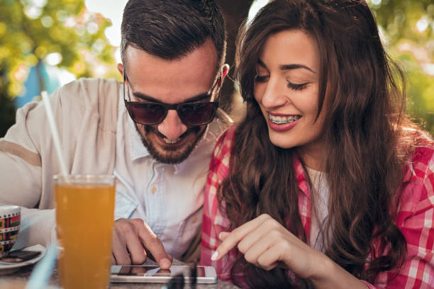 istock Beautiful young couple sitting together in cafe 681962658