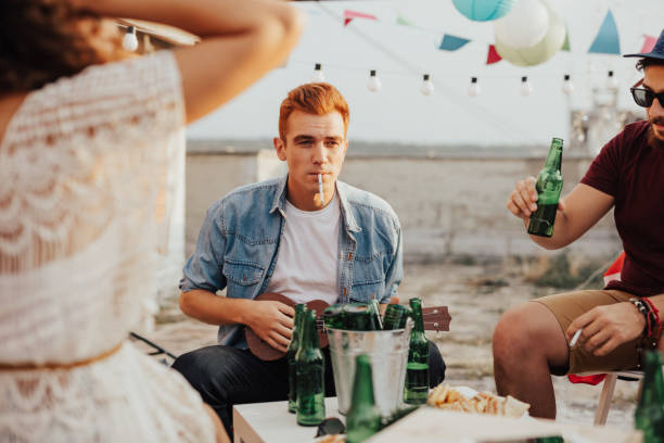 istock Redhaired man playing ukulele and smoking cigarettes 681965136