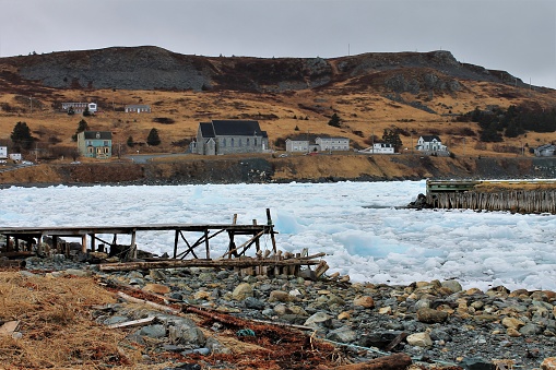Pack Ice in Ferryland, Newfoundland and Labrador, Canada, April 22, 2017. Looking across the beach at the ice in the bay and the town of Ferryland.