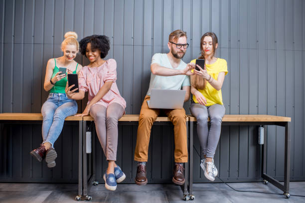 istock Group of young people with gadgets indoors 681979242