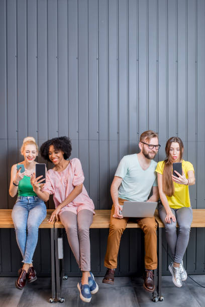 istock Group of young people with gadgets indoors 681979392