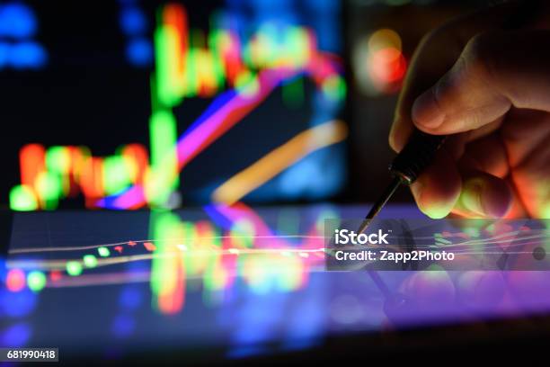 Arrow Dart And Man Finger With Graph Stock Market Trading Tablet Screen And Laptops Lcd Monitor Background Applied As Business And Stock Concept Forex Oil Gold Trading Concept Stock Photo - Download Image Now