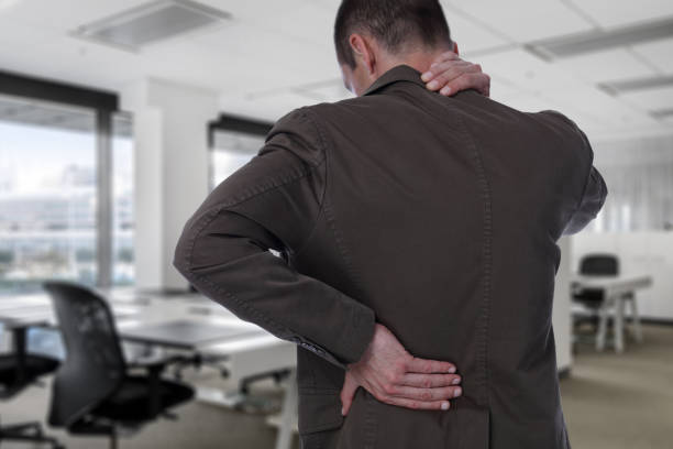 business man with back pain in office . pain relief concept - lower back pain imagens e fotografias de stock