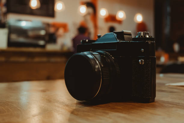 Retro vintage camera on wooden table indoors