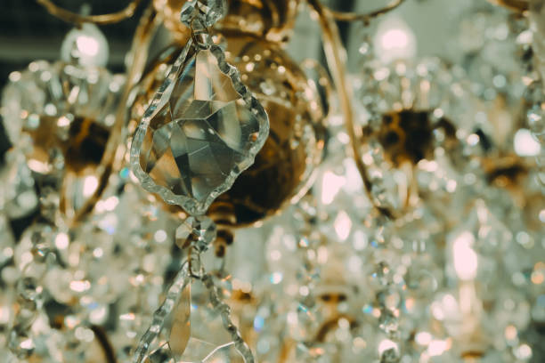 istock Chandelier crystal warm lights background at indoors 682005862