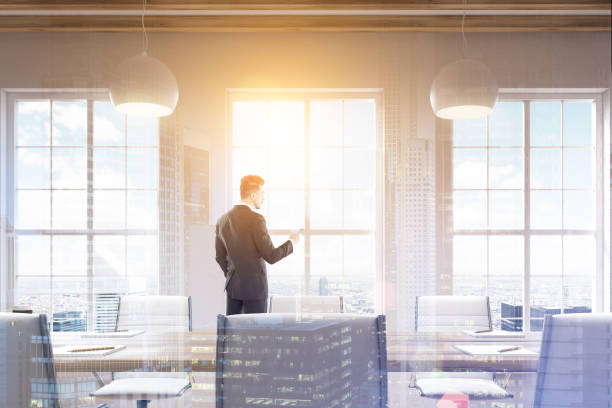 istock Man looking at phone in conference room, double 682014922