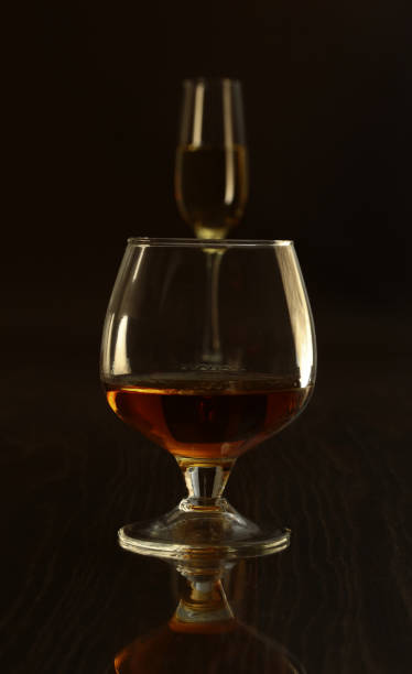 istock Glass with white, red wine and cognac or whisky on mirror table. Celebrities composition. selective focus 682014966