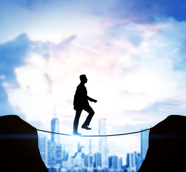 istock Businessman crossing bridge through a void 682017636