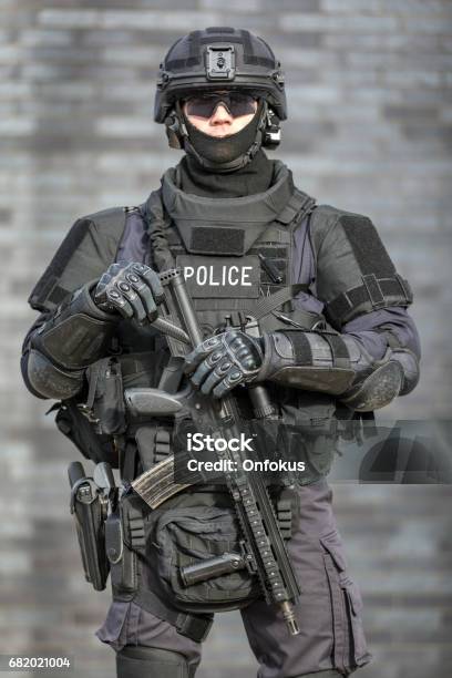 Swat Police Officer Against Brick Wall Stock Photo - Download Image Now - Police Force, Special Forces, SWAT Team