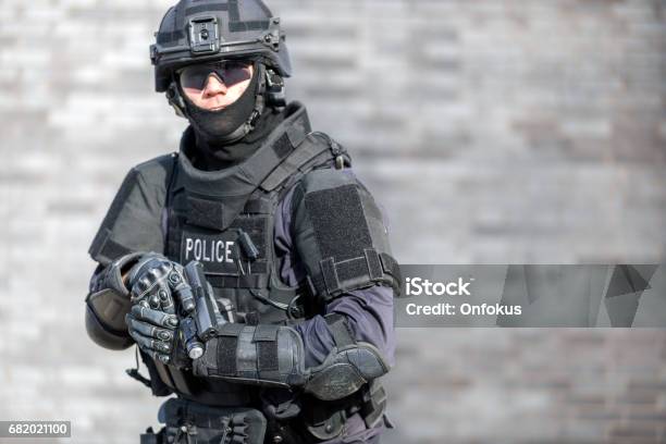 Swat Police Officer Against Brick Wall Stock Photo - Download Image Now - Police Force, Special Forces, SWAT Team