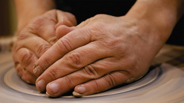 istock Potter is making clay pot on the potter's wheel 682028198