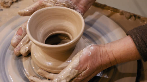 istock Potter is making clay pot on the potter's wheel 682028410