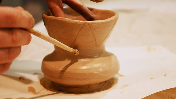 istock Potter is making clay pot on the potter's wheel 682028472
