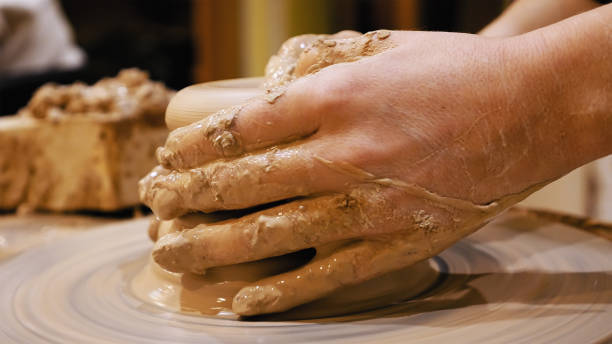 istock Potter is making clay pot on the potter's wheel 682028492