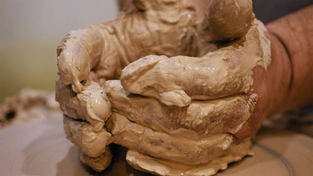 istock Potter is making clay pot on the potter's wheel 682028868