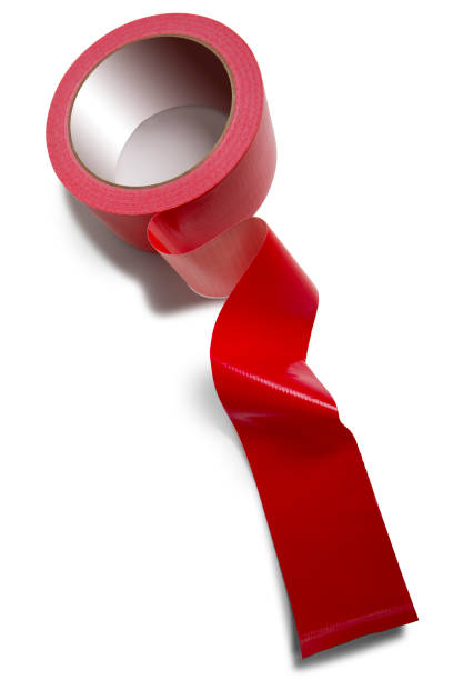 Red tape isolated on a white background This is a high angle photograph of a roll of red tape isolated on a white background with a drop shadow. There are no people in the shop. Frayed stock pictures, royalty-free photos & images