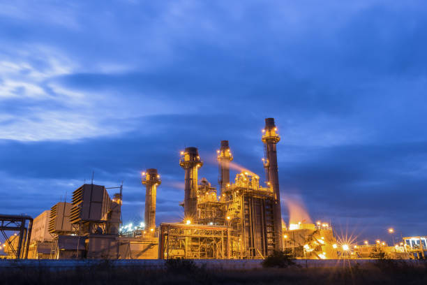 istock Gas turbine electrical power plant at dusk with raining sky 682042376