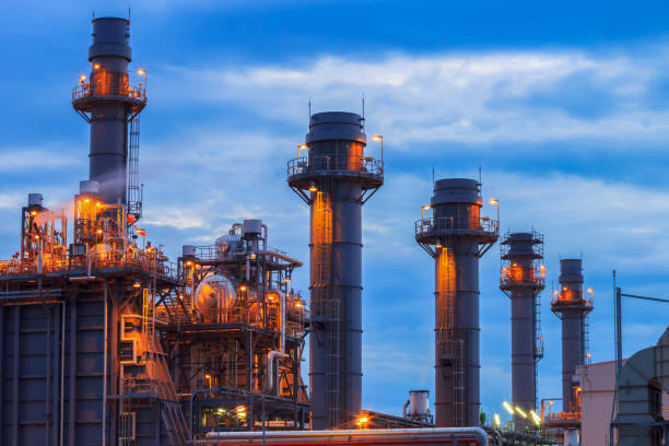 istock Gas turbine electrical power plant at dusk with raining sky 682042382