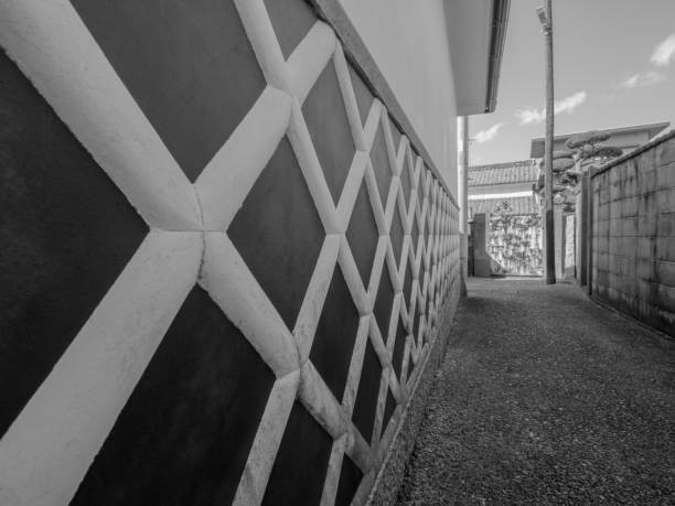 Narrow alley of Japanese old town in Yamaguchi prefecture. The wall of houses with lattice pattern is one of the famous architecture in old days and the damaged surface of the wall tells many years has been passed.