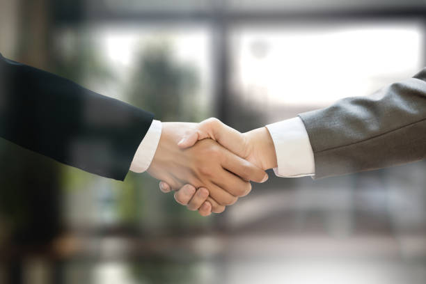 istock M&A (MERGERS AND ACQUISITIONS) , Businessman handshake working at office M&A 682049962